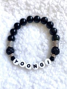 "Represent for Suga- or as we like to call him: Yoongi! BTS Yoongi Genuine Obsidian gemstone beaded bracelet in black to represent his mic color, with black and silver pavé accents. Letters are printed porcelain- NO PLASTIC. *Size can vary from 1/8\" to 1/4\" depending on bead type/size." Trendy Black Name Bracelet With Round Beads, Trendy Black Beaded Name Bracelet, Black Kpop Jewelry For Gift, Black Kpop Jewelry Gift, Trendy Personalized Black Bracelet, Black Personalized Kpop Jewelry, Personalized Black Kpop Jewelry, Personalized Black Bracelets With Round Beads, Black Kpop Style Jewelry With Letter Beads