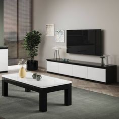 a modern living room with white and black furniture