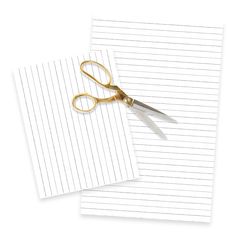 two pieces of lined paper with gold scissors on them