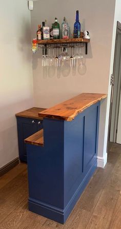 a blue bar with some bottles and glasses on the top shelf in front of it