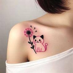 a woman's shoulder with a cat and dandelion tattoo on her left shoulder