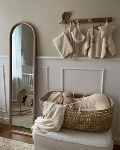 a baby's crib and mirror in a room