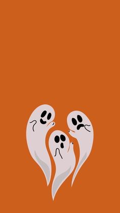 two ghost heads with their eyes closed on an orange background