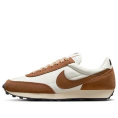 The Nike DBreak SE 'Rattan' is a stylish and comfortable women's sneaker that combines a classic running style from 1979 with modern materials. Its unique silhouette and texture make it stand out from the crowd. It is perfect for running, jogging, and other activities, and its brown and white colorway is inspired by the classic Nike Daybreak series. The rubber sole provides superior cushioning and support, making it a great choice for any woman who wants to look stylish while staying active. Release date: 2022-06-27. (SNKR/Retro/Low Top/Women's) Vintage Nike Sneakers With Boost Midsole, Vintage Nike Sneakers With Boost Technology, Retro Nike Sneakers With Rubber Sole, Nike Retro Brown Sneakers, Retro Nike Running Shoes, Sporty Brown Sneakers With Rubber Waffle Outsoles, Retro Lace-up Running Shoes With Boost Midsole, Vintage Lace-up Sneakers With Cushioned Footbed, Nike Retro Sneakers With Boost Midsole