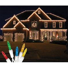 lighted christmas lights in front of a house