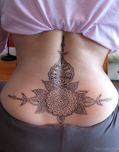 the back of a woman's stomach with an intricate design on it