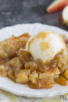 a close up of a plate of food with ice cream on top of it and apples in the background