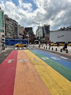 a rainbow painted street in the middle of a city