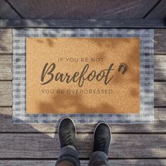 someone standing in front of a door mat that says if you're not barefoot, you're overdresed