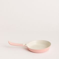 a pink and white spoon sitting on top of a table