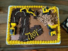 a birthday cake with construction trucks and dirt on it