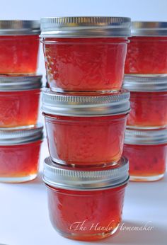 several jars filled with jam sitting on top of a table