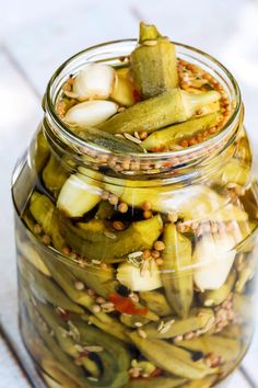 pickles and onions are in a jar on the table