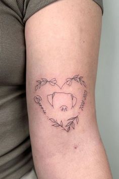 a woman's arm with a heart shaped pig tattoo on the left side of her body