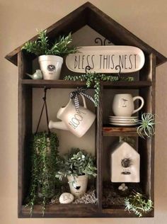 a shelf filled with pots and plants next to a sign that says bliss this nest