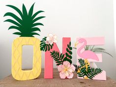 a pineapple and pink flamingo are next to the letters'nf '