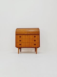 a wooden dresser with three drawers on one side and an open drawer on the other