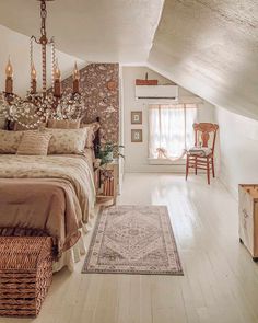 a bedroom with a bed, chair and rug in it's attic room area