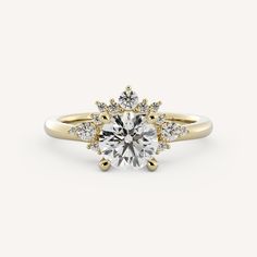 a yellow gold engagement ring with diamonds on the side