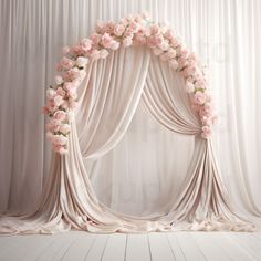 a wedding arch decorated with pink flowers