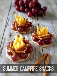 grapes, cheese and crackers are arranged on small sandwiches