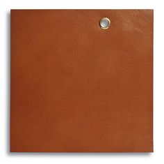 a brown piece of leather with a hole in the middle