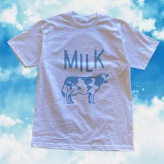 This retro kawaii clothing was inspired by japanese kawaii aesthetic and kawaii fashion. This kawaii t shirt features a retro - grunge textured vintage inspired Milk Print with originally designed cow on it. It's perfect for any pastel clothing lovers who just want to keep it minimal for their every day. It's a perfect gift for her, gift for him or anyone in between as these shirts are unisex. Available in Sizes XS, S, M, L, XL, 2XL and 3XL. ✨ 100% ⭐️ PREMIUM ⭐️ Airlume combed and ringspun cotto Kawaii Cotton T-shirt With Letter Print, White Kawaii Tops With Graphic Print, White Kawaii Top With Graphic Print, White Harajuku Top With Funny Print, Kawaii White Top With Funny Print, White Harajuku Cotton Shirt, White Harajuku Style Cotton Shirt, White Harajuku Style Cotton T-shirt, White Kawaii Top With Funny Print