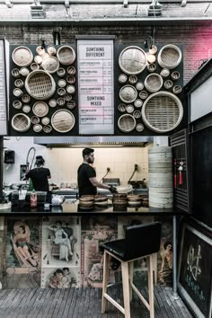 a man standing behind a counter in a restaurant