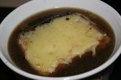 a white bowl filled with soup on top of a stove