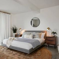 a bedroom with a large bed and white walls