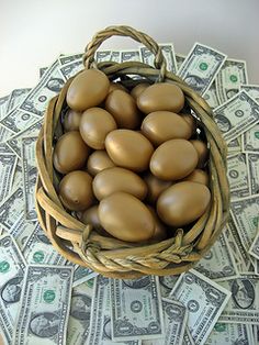 a basket filled with brown eggs sitting on top of money