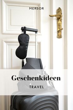 a suitcase sitting in front of a door with the words gessenkiden travel