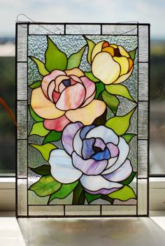 a close up of a stained glass window with flowers