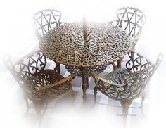 the table and chairs are all made out of wood with intricate carvings on them,