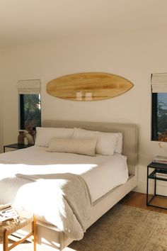 a bedroom with a surfboard mounted to the wall