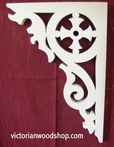 a decorative white shelf bracket on a red background