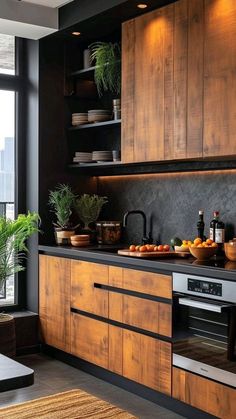 a kitchen with wooden cabinets and black counter tops, potted plants on the window sill