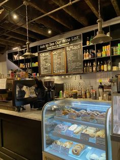 the inside of a bakery with donuts on display