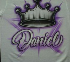 a white tank top with the word danielle painted on it and a crown in purple