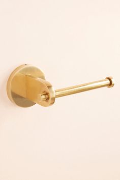 a gold door handle on a white wall