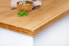 a bowl of food sitting on top of a wooden counter