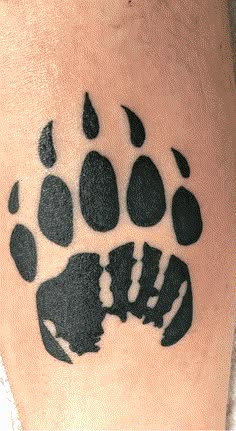 a black and white photo of a bear paw tattoo