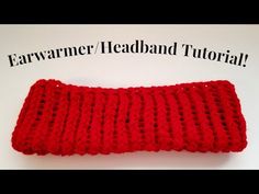 a red crocheted headband sitting on top of a white table