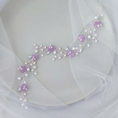 This purple hair piece is made of:  - acrylic flowers - glass pearls - crystal rhinestones  - jewelry wire.  On the picture of the product you see a product using : purple flowers, white  glass pearls, clear crystal rhinestones and high quality silver jewelry wire. The length of the decoration on the photo is 12 inches Additional Information  -Product will be placed into a gift box -If you need a different color, you can choose it in the list -100% handmade If you need jewelry or accessories in the color of your wedding, please let me know about it. I will certainly make it the way you need it. Orders typically ship within 1-3 days after purchase  And within 2-5 days after purchase (if you order custom made) All our buyers receive a track number to control location of the parcel at any tim Purple Hair Accessories Wedding, Pearls Hair, Pearl Bridal Hair, Pearl Hair Vine, Bridal Hair Vine, Purple Pearl, Pearl Bridal, Flowers White, Lilac Flowers