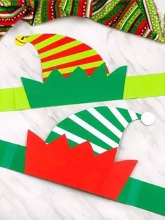 the paper hats are on top of each other and have green, red, and yellow stripes