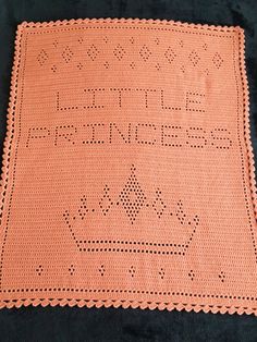 an orange crocheted afghan with words on it