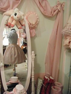 there is a large mirror in the room with pink accessories on it and a stuffed animal