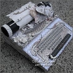 an old typewriter is laying on the ground with papers and other items around it