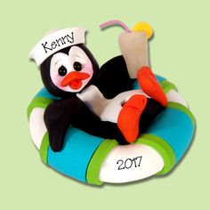 a cake shaped like a penguin on a life preserver with the name kenny written on it