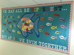 a bulletin board with fish on it in a school hallway or playroom for children